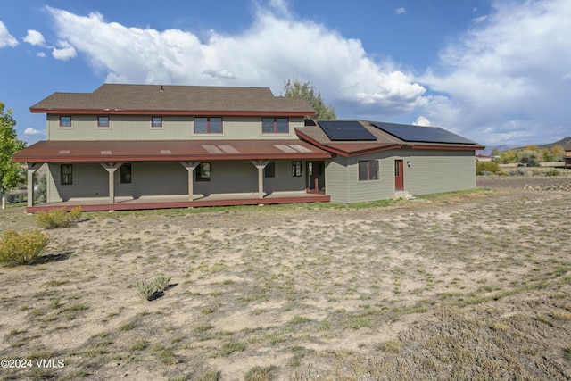 back of house with solar panels