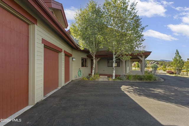 104 Chaparral Ranch Rd, Gypsum, CO 81637 - view of side of property featuring driveway, a porch, and an attached garage