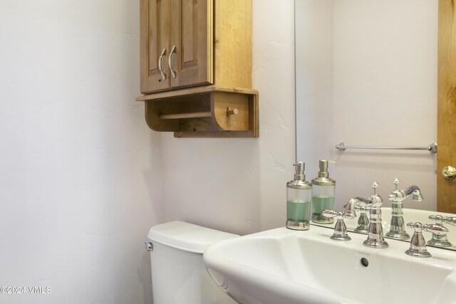 bathroom with toilet and sink