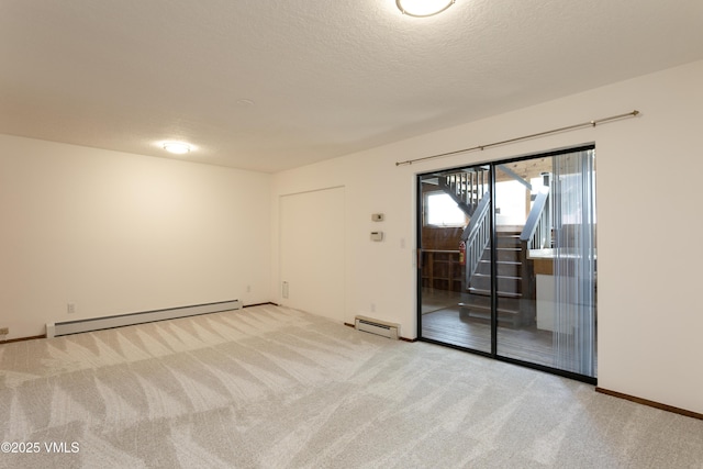 717 Bull Run Unit A, Eagle, CO 81631 - carpeted spare room with a baseboard radiator, baseboard heating, stairway, and a textured ceiling