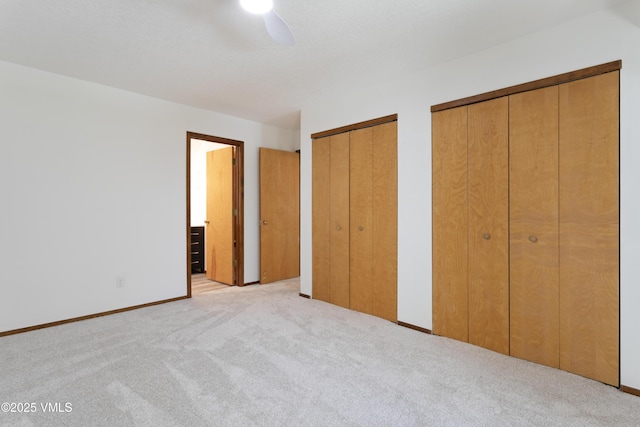 717 Bull Run Unit A, Eagle, CO 81631 - unfurnished bedroom featuring carpet, multiple closets, and ceiling fan
