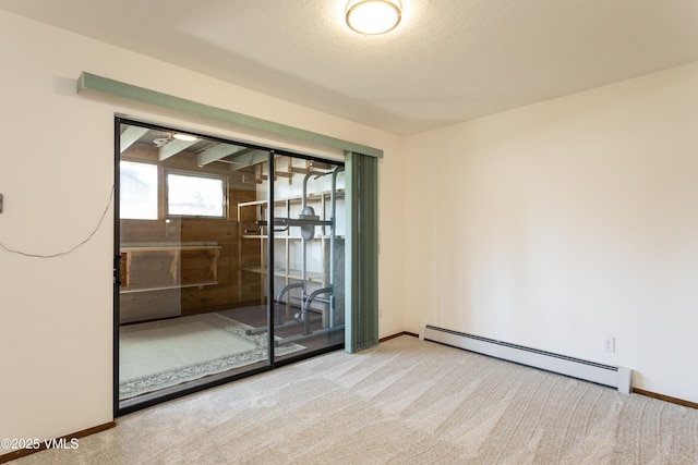 717 Bull Run Unit A, Eagle, CO 81631 - empty room with a baseboard radiator and carpet floors