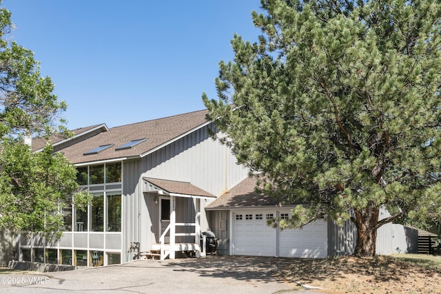 717 Bull Run Unit A, Eagle, CO 81631 - view of front of home with roof with shingles, concrete driveway, entry steps, and a garage