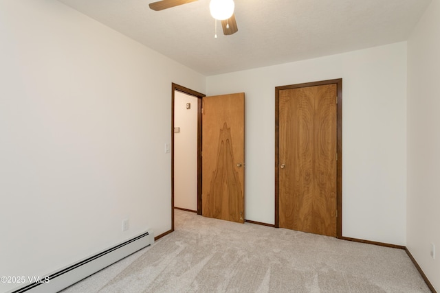 717 Bull Run Unit A, Eagle, CO 81631 - unfurnished bedroom with a baseboard heating unit, carpet floors, a closet, and a ceiling fan
