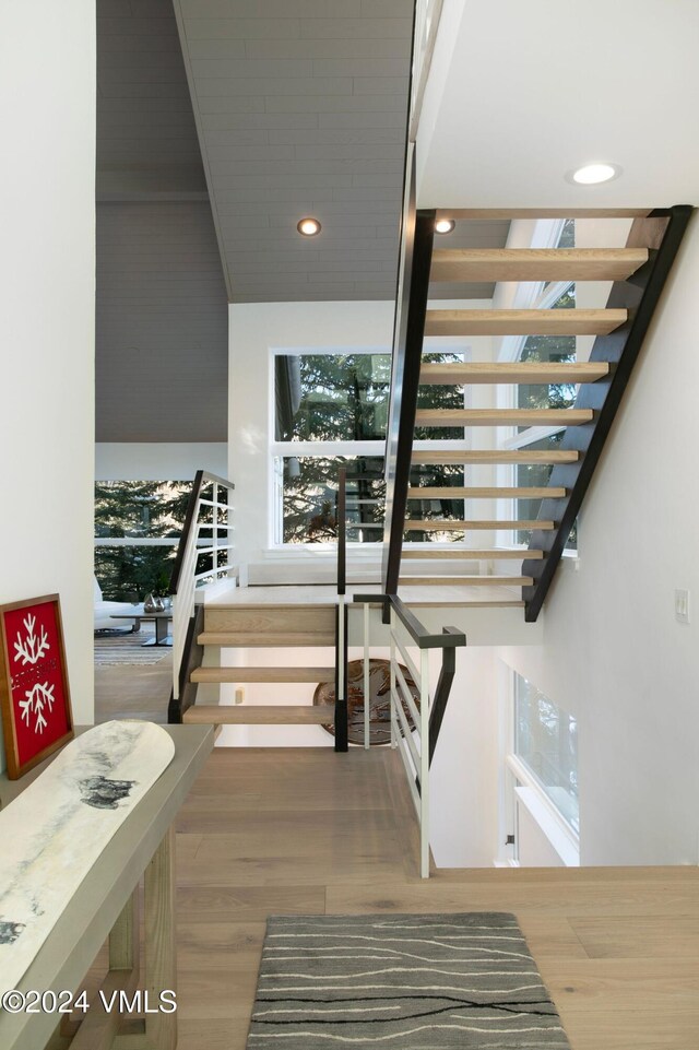 stairs featuring recessed lighting and wood finished floors