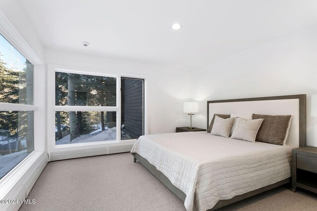 carpeted bedroom with recessed lighting