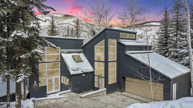 exterior space featuring a garage, french doors, and a mountain view