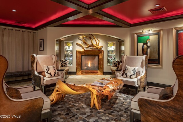 26 Avondale Ln Unit 114-H, Beaver Creek, CO 81620 - sitting room with coffered ceiling, arched walkways, a lit fireplace, and beam ceiling