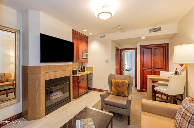 26 Avondale Ln Unit 114-H, Beaver Creek, CO 81620 - living room with a fireplace, baseboards, recessed lighting, and light wood-type flooring