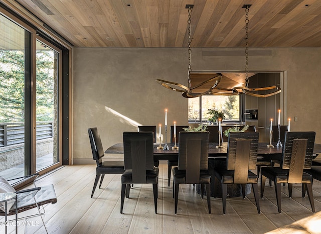 dining space featuring wood ceiling and light hardwood / wood-style flooring