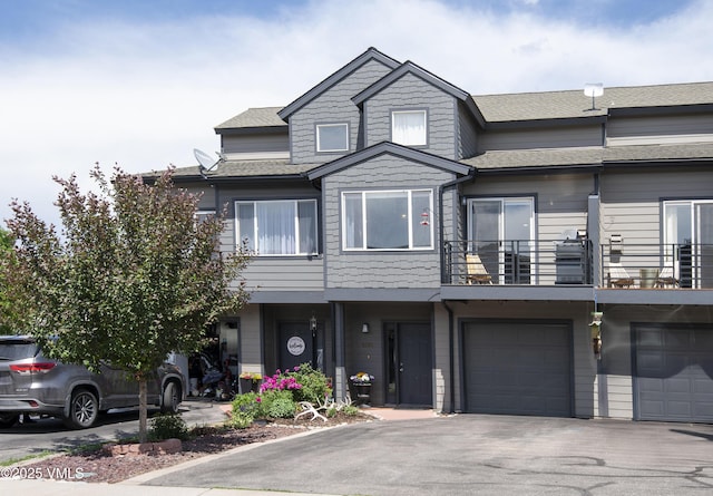 104-2 Quail Cir, Gypsum, CO 81637 - townhome / multi-family property with an attached garage, a balcony, driveway, and a shingled roof