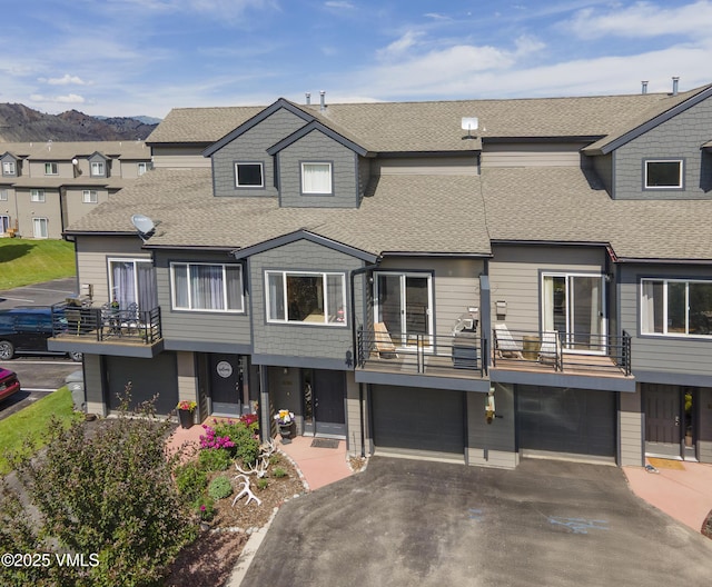 104-2 Quail Cir, Gypsum, CO 81637 - view of property with roof with shingles, a balcony, a garage, and driveway