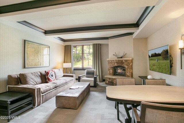 130 Daybreak Rdg Unit 732, Avon, CO 81620 - carpeted living area featuring wallpapered walls, a fireplace, and beamed ceiling