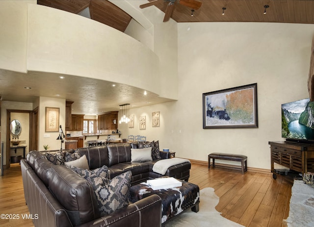 1120 Village Rd Unit 7, Beaver Creek, CO 81620 - living room featuring baseboards, a high ceiling, wood ceiling, light wood finished floors, and a ceiling fan