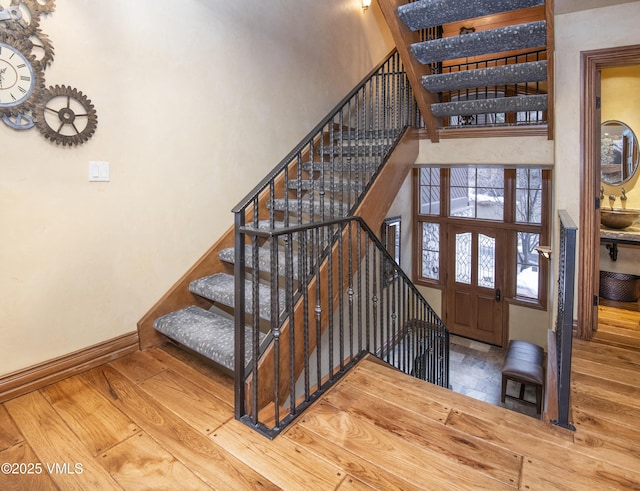 1120 Village Rd Unit 7, Beaver Creek, CO 81620 - stairway with hardwood / wood-style floors, baseboards, and a high ceiling