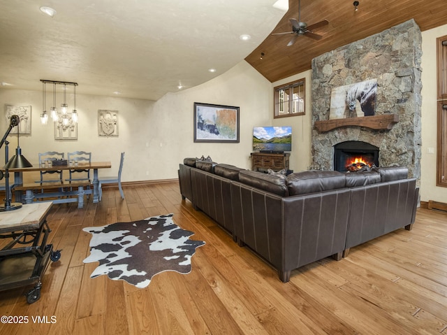 1120 Village Rd Unit 7, Beaver Creek, CO 81620 - living room featuring light wood-style flooring, baseboards, ceiling fan, a stone fireplace, and lofted ceiling