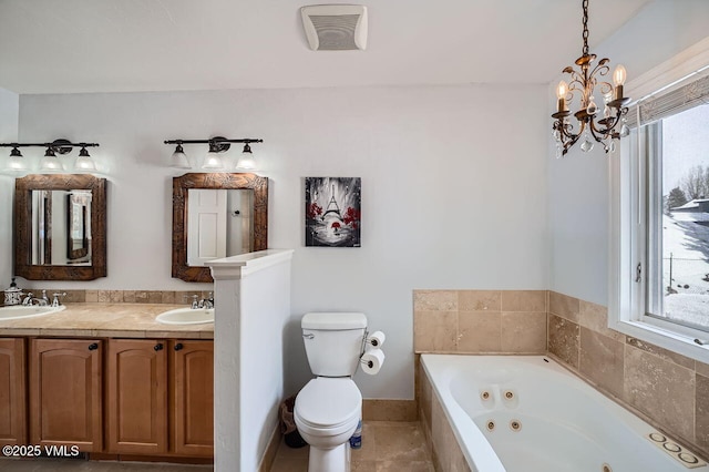 bathroom featuring a jetted tub, a sink, visible vents, and a healthy amount of sunlight