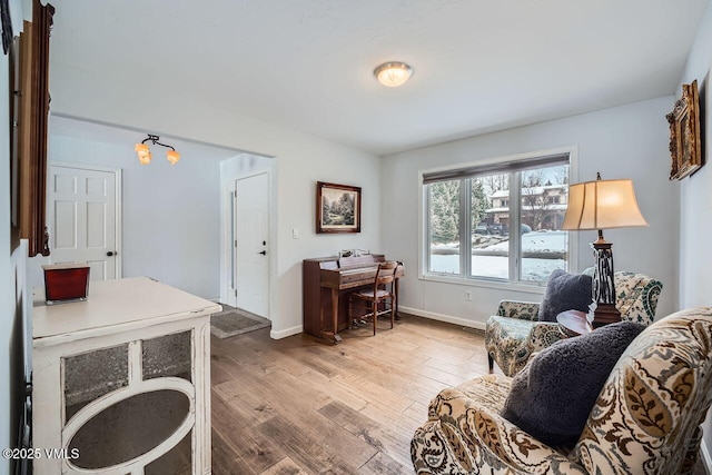 home office with baseboards and wood finished floors