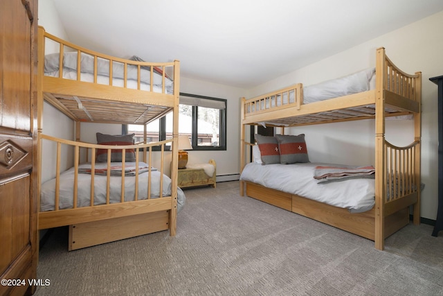 carpeted bedroom featuring a baseboard heating unit