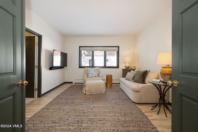 living room with light hardwood / wood-style flooring and a baseboard radiator