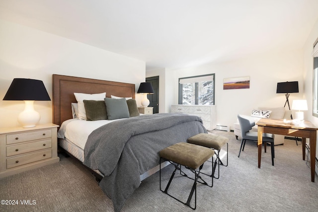 bedroom featuring a baseboard heating unit and carpet flooring