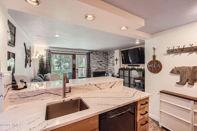 4570 Vail Racquet Club Dr Unit 2-3, Vail, CO 81657 - kitchen featuring dishwasher, open floor plan, a fireplace, light stone counters, and recessed lighting