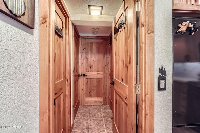 4570 Vail Racquet Club Dr Unit 2-3, Vail, CO 81657 - hall featuring a textured wall and tile patterned flooring