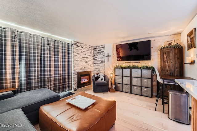 4570 Vail Racquet Club Dr Unit 2-3, Vail, CO 81657 - living area with a stone fireplace and wood finished floors
