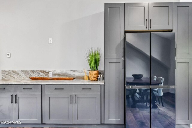 kitchen with stainless steel fridge and gray cabinets