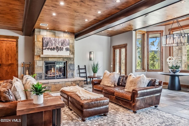 living room with wood ceiling, a fireplace, and beamed ceiling