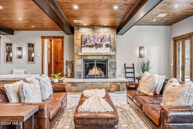 living room with beamed ceiling, a fireplace, and wooden ceiling