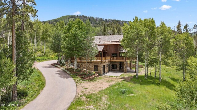 rear view of property featuring a wooden deck