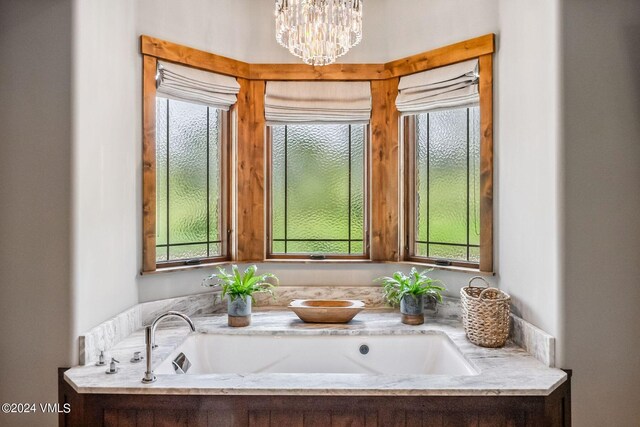 bathroom featuring a notable chandelier