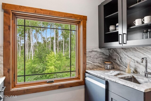 doorway to outside featuring plenty of natural light and sink