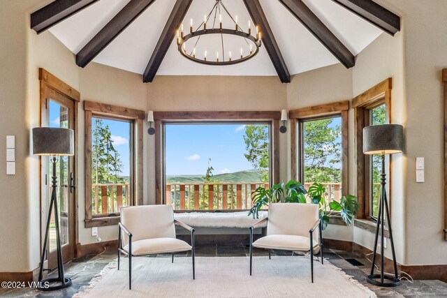 sunroom with vaulted ceiling with beams, plenty of natural light, and a chandelier