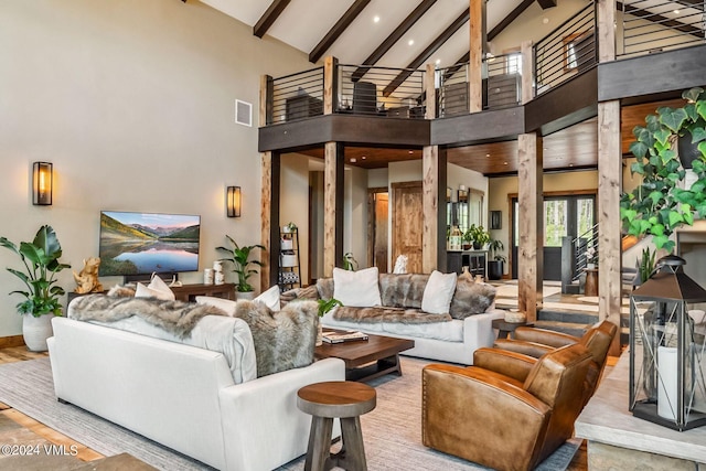 living room with high vaulted ceiling and beamed ceiling