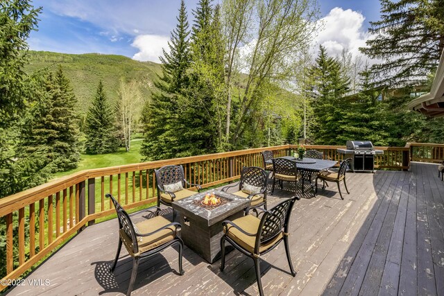 wooden deck featuring an outdoor fire pit