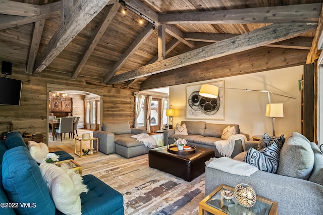 living room featuring high vaulted ceiling, hardwood / wood-style flooring, wood ceiling, track lighting, and beam ceiling