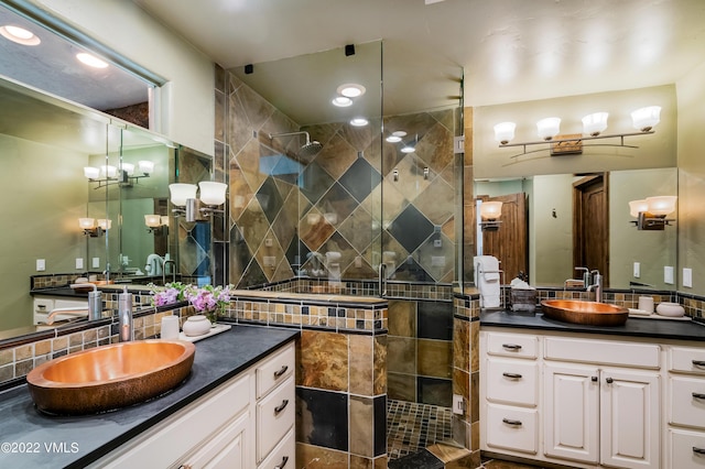 bathroom featuring vanity, tasteful backsplash, and a tile shower