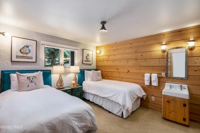 bedroom with sink and light carpet