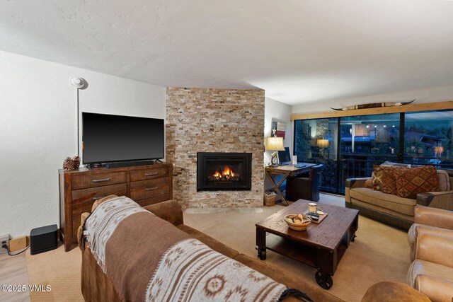 carpeted living room featuring a fireplace