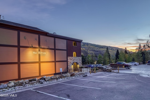 parking at dusk featuring a mountain view