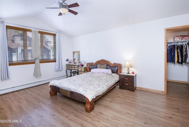 1082 W Wildwood Rd Unit C, Avon, CO 81620 - bedroom featuring light wood finished floors, vaulted ceiling, a spacious closet, a baseboard radiator, and ceiling fan