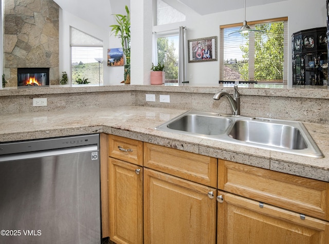 1082 W Wildwood Rd Unit C, Avon, CO 81620 - kitchen with dishwasher, healthy amount of natural light, a large fireplace, and decorative light fixtures
