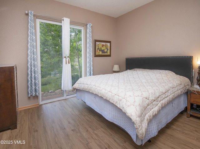 1082 W Wildwood Rd Unit C, Avon, CO 81620 - bedroom with wood finished floors and access to outside