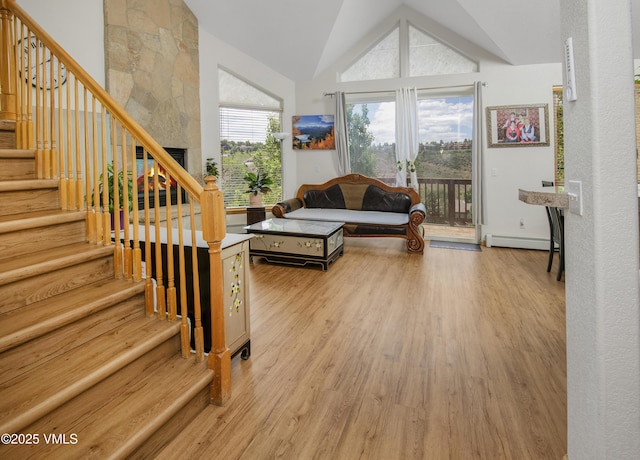 1082 W Wildwood Rd Unit C, Avon, CO 81620 - living room featuring wood finished floors, lofted ceiling, stairs, and baseboard heating