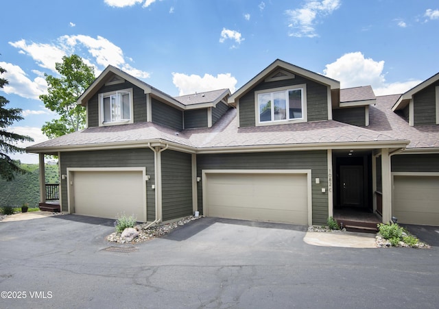 1082 W Wildwood Rd Unit C, Avon, CO 81620 - view of front of property featuring asphalt driveway, a garage, and a shingled roof
