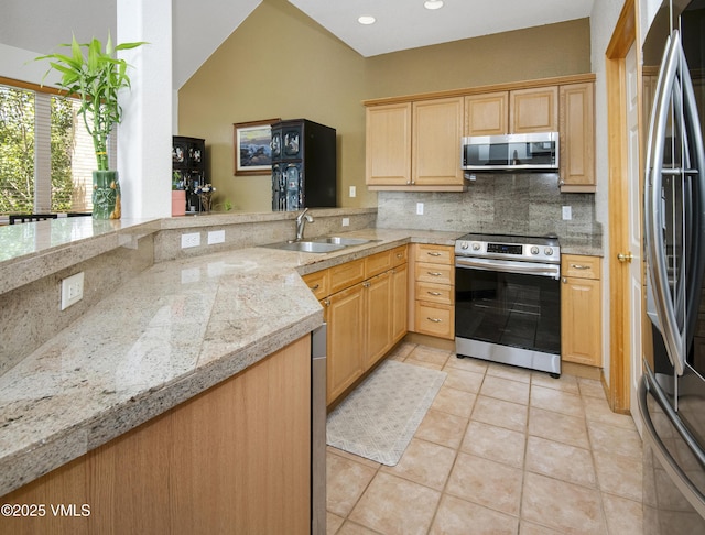 1082 W Wildwood Rd Unit C, Avon, CO 81620 - kitchen with stainless steel appliances, backsplash, light brown cabinets, and recessed lighting