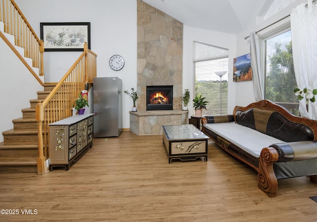 1082 W Wildwood Rd Unit C, Avon, CO 81620 - living area with stairway, light wood finished floors, a fireplace, and high vaulted ceiling