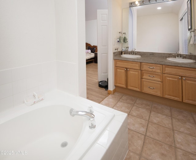1082 W Wildwood Rd Unit C, Avon, CO 81620 - ensuite bathroom with double vanity, a garden tub, and tile patterned floors